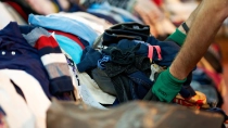 Person sorting second hand clothes